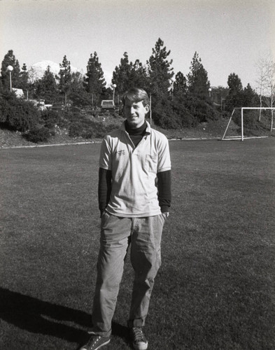 Student standing on an athletic field, Claremont McKenna College