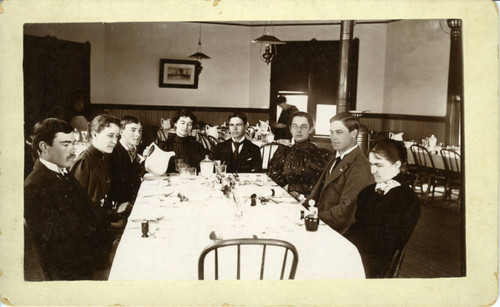 Students sitting around a table, dining hall, Pomona College
