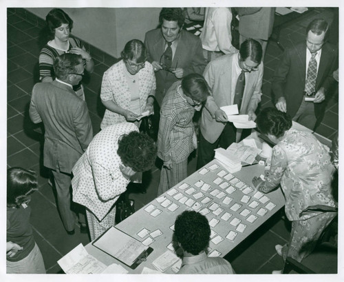 Individuals gather near a table, Claremont McKenna College