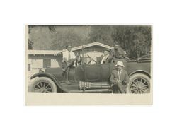 John W. Boyle, three men, and a dog posing with Ford Model-T