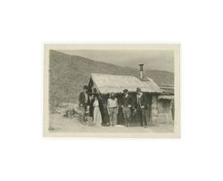 Director J. Gordon Edwards, John W. Boyle, and actors in front of a shack