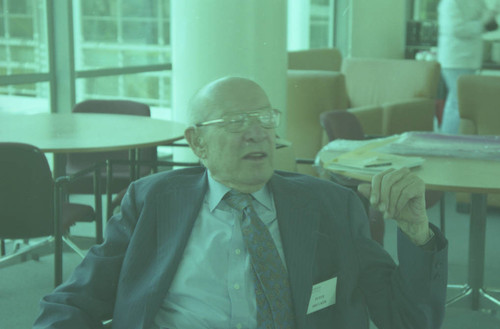 Peter Drucker sitting in a chair