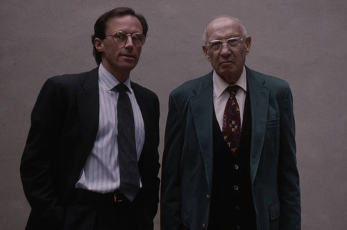 Peter Drucker stands next to an individual