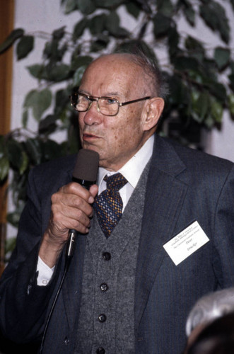 Peter Drucker speaking into a microphone