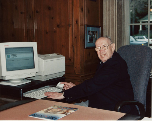 Peter Drucker sitting at a desk