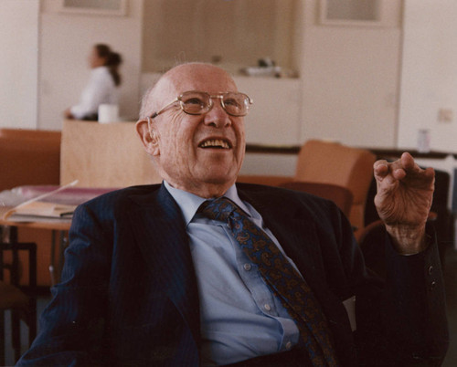 Peter Drucker sitting in a chair