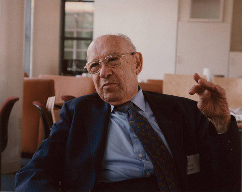 Peter Drucker sitting in a chair