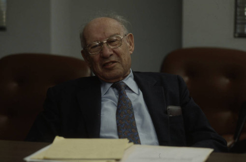 Peter Drucker sitting at a table