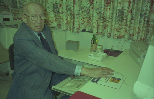 Peter Drucker sitting at a desk