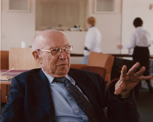 Peter Drucker sitting in a chair