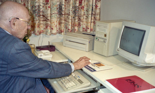 Peter Drucker sitting at a desk