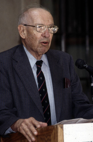 Peter Drucker standing behind a podium