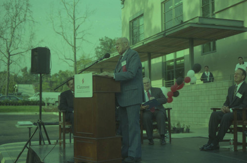 Peter Drucker standing behind a podium