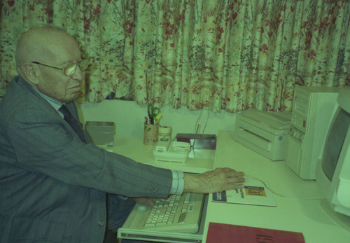 Peter Drucker sitting at a desk