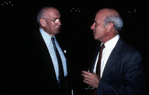 Peter Drucker standing next to an individual