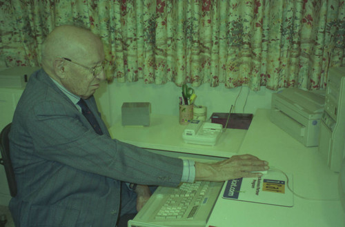 Peter Drucker sitting at a desk