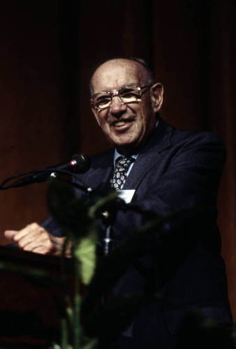 Peter Drucker standing behind a podium