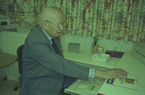 Peter Drucker sitting at a desk