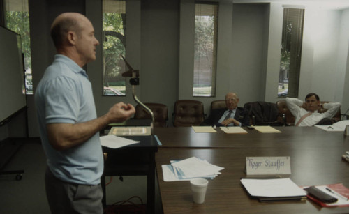 Peter Drucker and an individual listening to a speaker