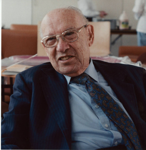 Peter Drucker sitting in a chair