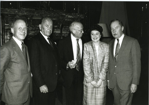 Peter Drucker standing between four individuals