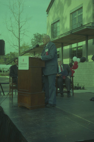 Peter Drucker standing behind a podium