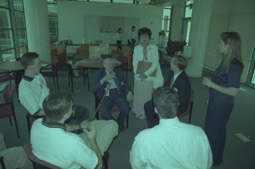 Peter Drucker sitting with a group inside the Drucker Institute