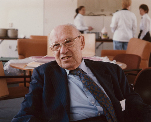 Peter Drucker sitting in a chair