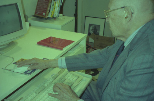 Peter Drucker sitting at a desk