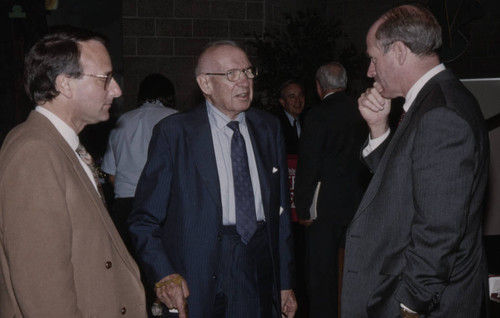 Peter Drucker standing between two individuals