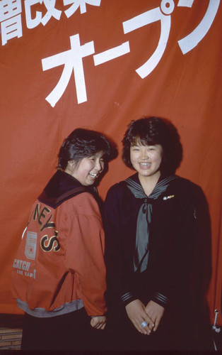 Teens standing near banner