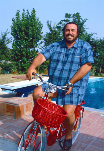 Luciano Pavarotti on red bicycle