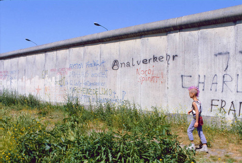 Punk boy walking by wall