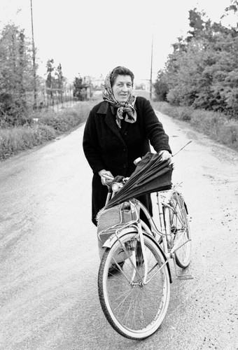 Woman with bicycle and umbrella