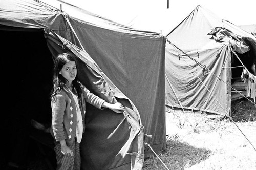 Child at tent entrance