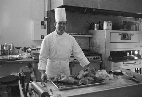 Owner in kitchen with roasted ducks