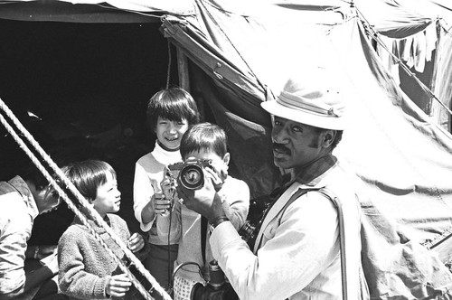 Man and child holding camera