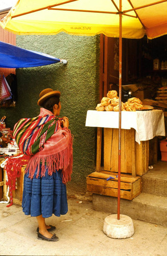 Woman standing beneath umbrella