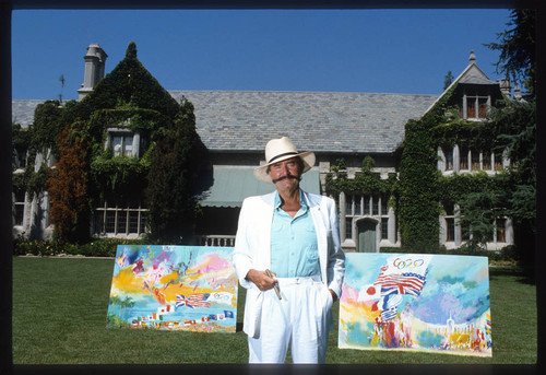 Leroy Neiman standing with hat