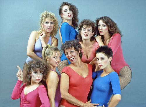 Dancers in multi-colored leotards and fishnet stockings