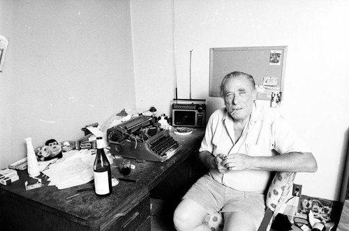 Charles Bukowski at his desk