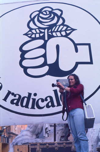 Photographer in front of radical party banner