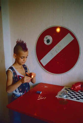 Punk boy playing with matches