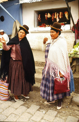 Woman in bowler hats at a market