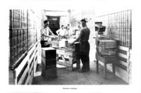 Cannery workers machine labeling cans