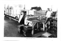 Cannery worker at cooking and cooling machines