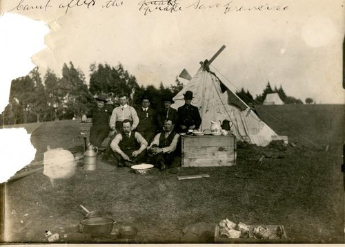 Displaced victims of the earthquake in front of a temporary tent shelter