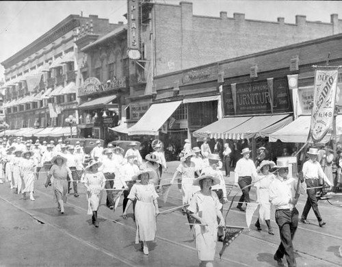 Men and women marching in a parade