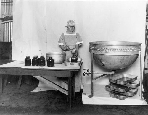 Woman filling glass jars