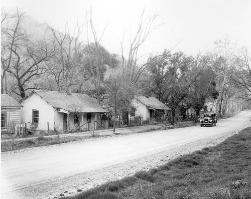 Car driving down dirt road